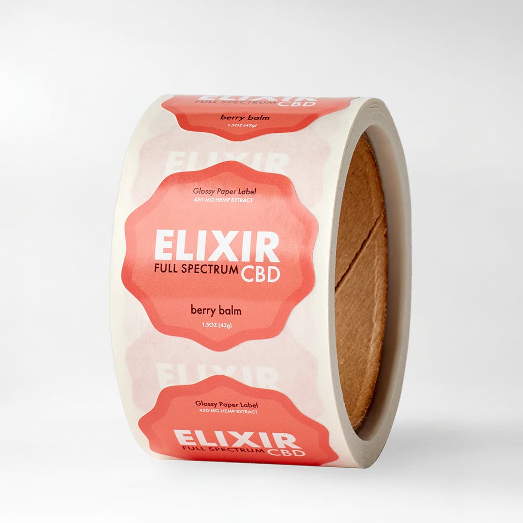 Roll of Elixir Full Spectrum CBD glossy paper labels with vibrant full color printing for wellness product packaging.