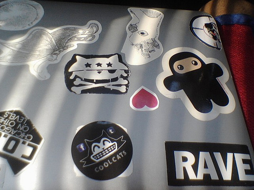 A laptop computer covered with cool stickers.