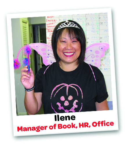 Ilene-from-StickerGiant-in-front-of-the-company-SOR-Board-with-fairy-wings-and-a-pen-wand-for-Halloween