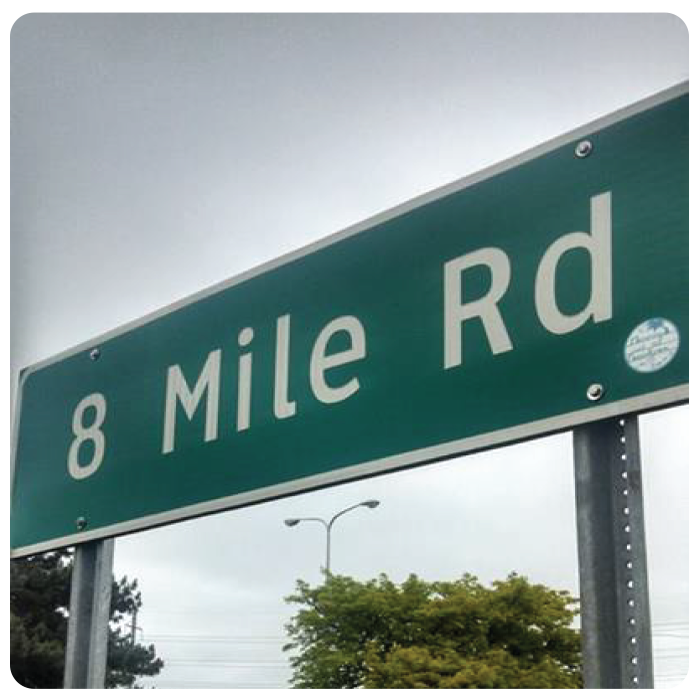 a sticker on the 8 Mile Rd sign