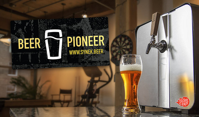 Custom-sticker-saying-Beer-Pioneer-for-Synek-Brewery-with-beer-glass-and-tap-of-bar-in-background-custom-stickers-were-printed-by-StickerGiant