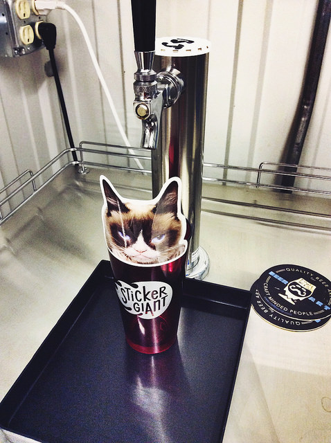 Grumpy-Cat-custom-shaped-sticker-in-a-pint-glass-with-the-kegerator-at-StickerGiant