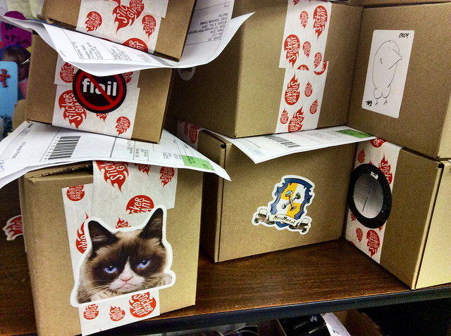 Grumpy-Cat-custom-shaped-sticker-on-a-box-ready-to-be-shipped-from-StickerGiant