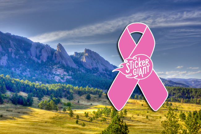 Breast-cancer-awareness-pink-ribbon-stickers-printed-by-StickerGiant-with-flat-iron-mountains-in-background