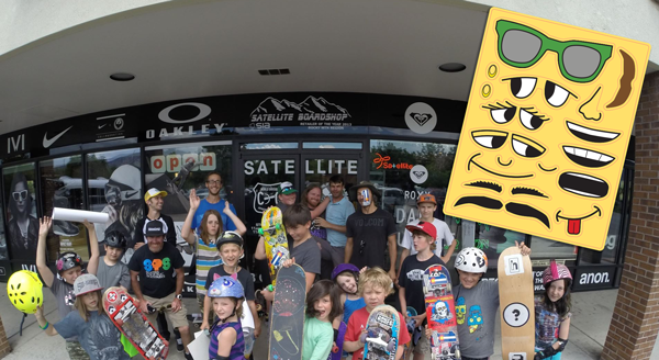 Group-of-Skaters-in-front-of-Satelite-Skate-Shop-in-Longmont-CO-with-a-custom-sticker-sheet-design-printed-by-StickerGiant-in-the-foreground