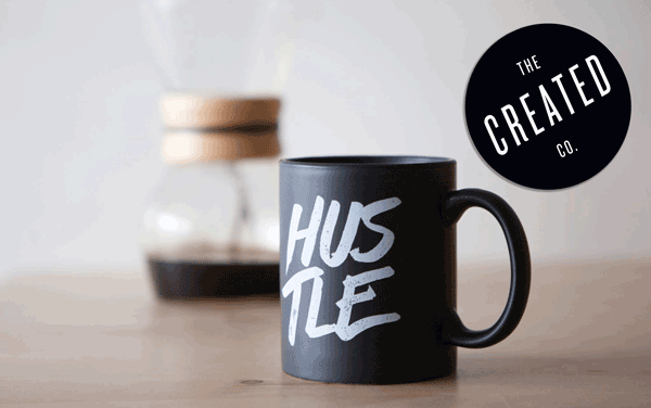 Custom-circle-logo-sticker-printed-by-StickerGiant-for-The-Created-Co.-with-a-coffee-mug-in-the-background