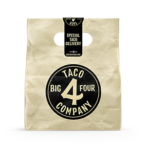 A paper bag with a black paper label printed by StickerGiant over the top of the bag sealing it, and a black circle sticker with Big 4 Taco Company logo printed by StickerGiant applied to the side of bag